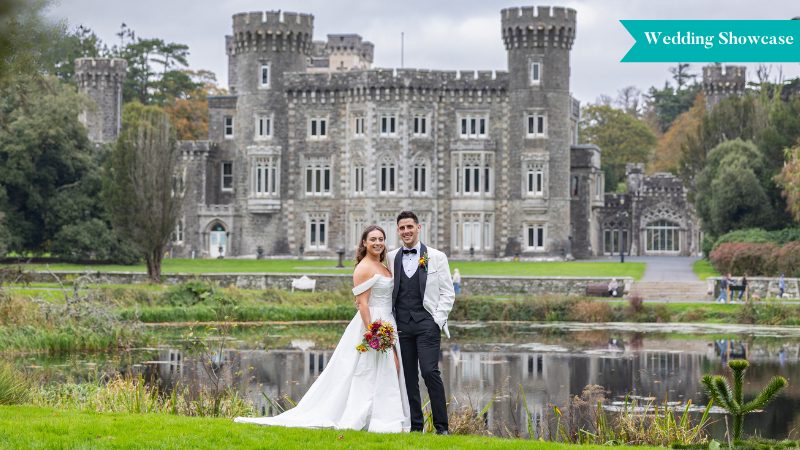 A happy wedding couple pictured with Johnstown Castle behind them.