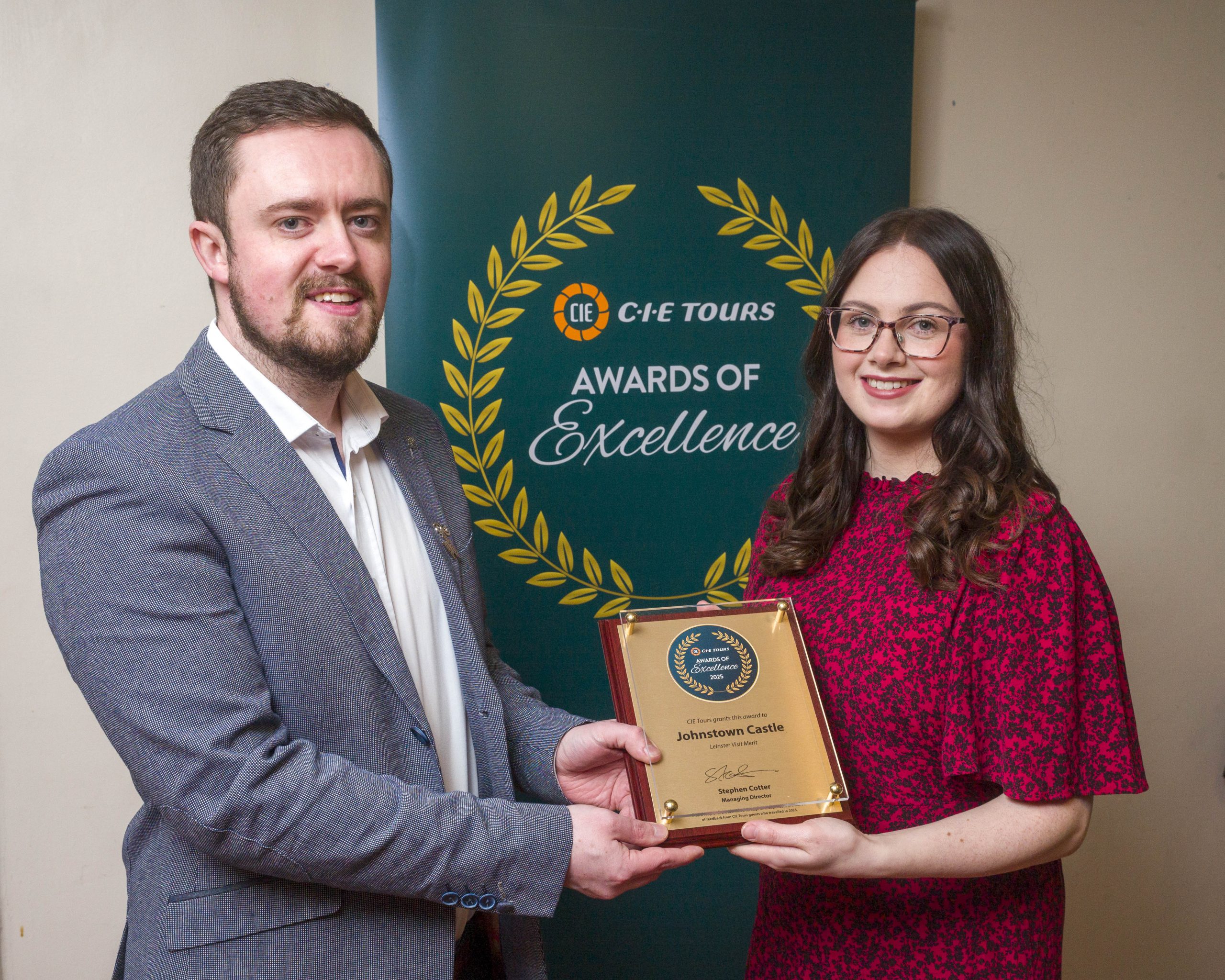 Eoin Ennis, Business Development and Promotions Manager, and Caoimhe Connick, Events and Digital Marketing Coordinator, holding the MERT Award plaque