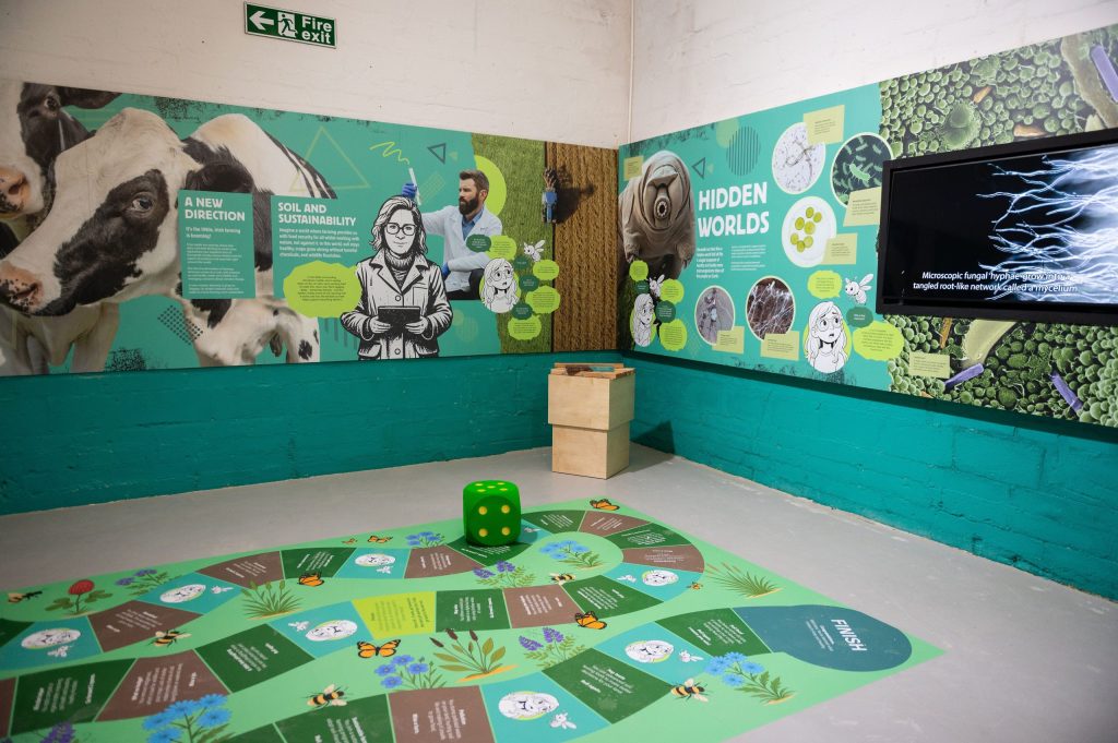 A section of the new Changing Farming Fortunes exhibition, highlighting the hidden world of soil and a snakes & ladders game with dice on the ground for children to play.