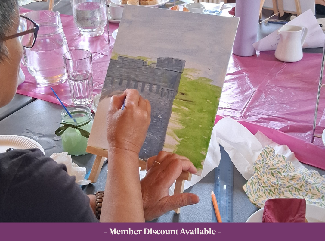 Beginner artist painting an image of Johnstown Castle