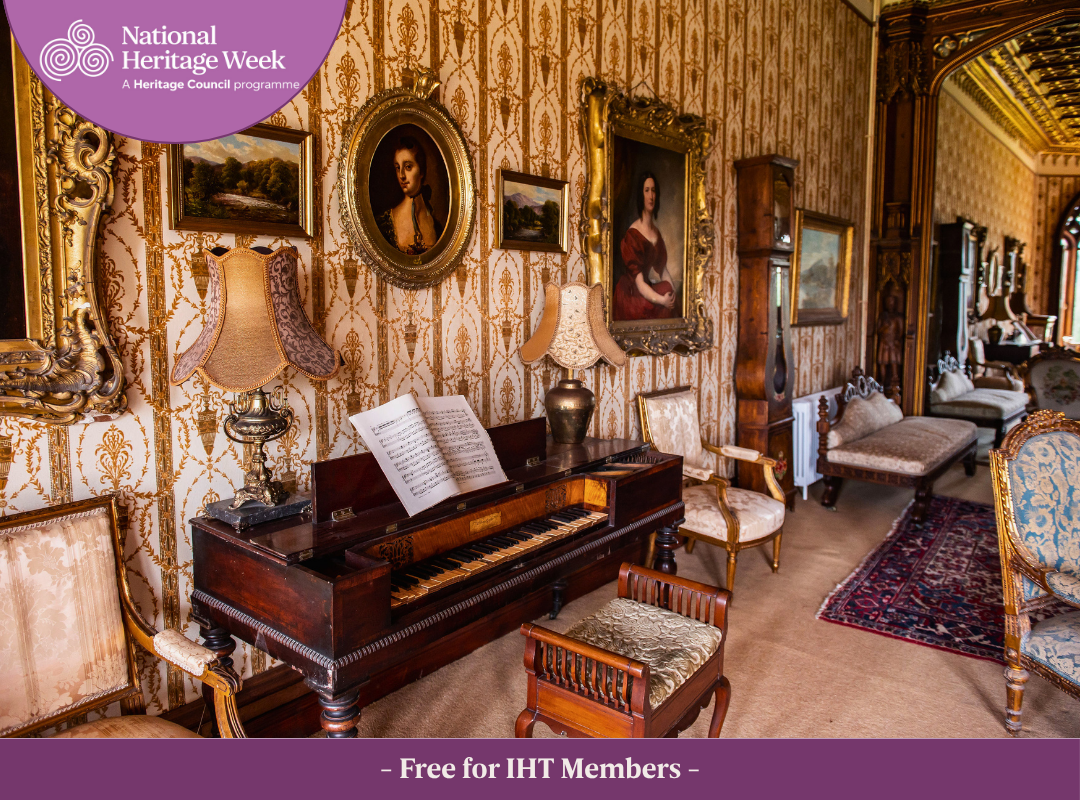 View of the Drawing Room at Johnstown Castle featuring ornate Victorian wallpaper, a grand piano, period artwork and upholstered seating. The Heritage Week logo appears in the top left corner, with the text "Free for IHT Members" displayed at the bottom of the image.