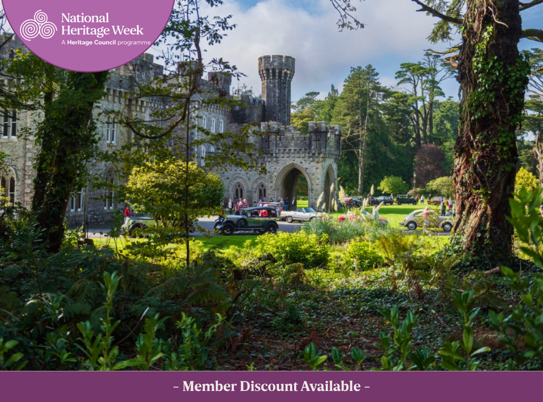 East view of Johnstown Castle framed by mature trees, with visitors and vintage cars in the foreground. featuring the Heritage Council logo and the text: 'Discount available to IHT Members'