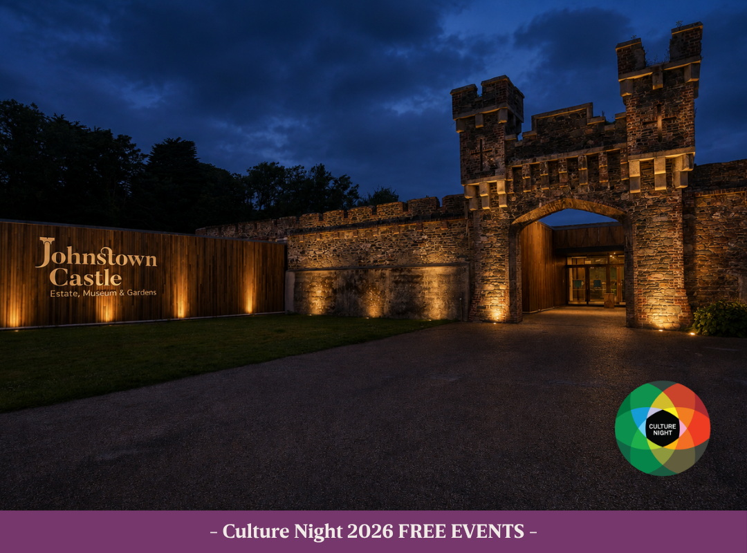 The entrance to the Johnstown Castle Visitor Centre at Night. Lit up with warm white lights. Culture Night logo on the bottom right of image.