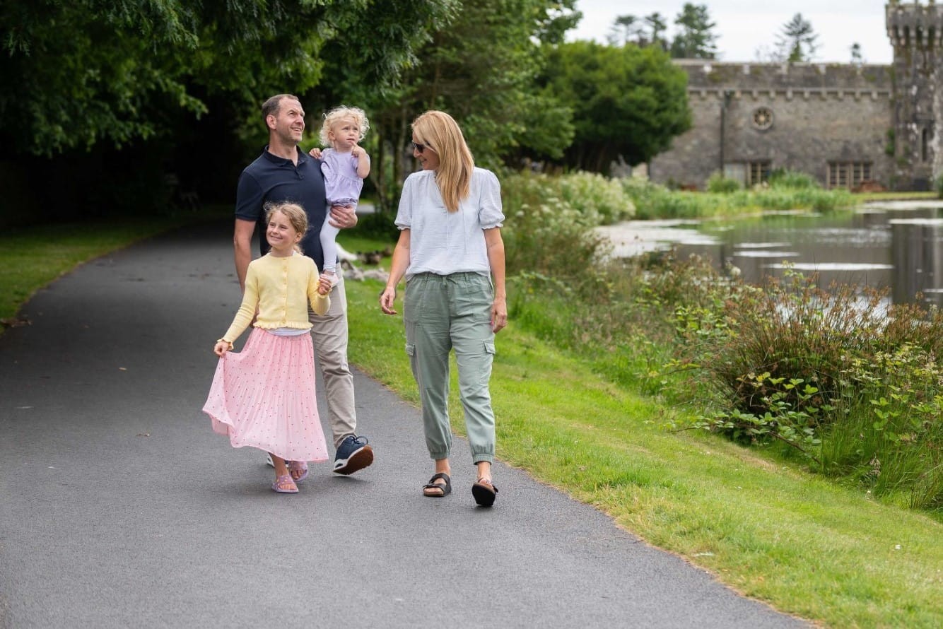 Family walking beside lake at Johnstown Castle Estate